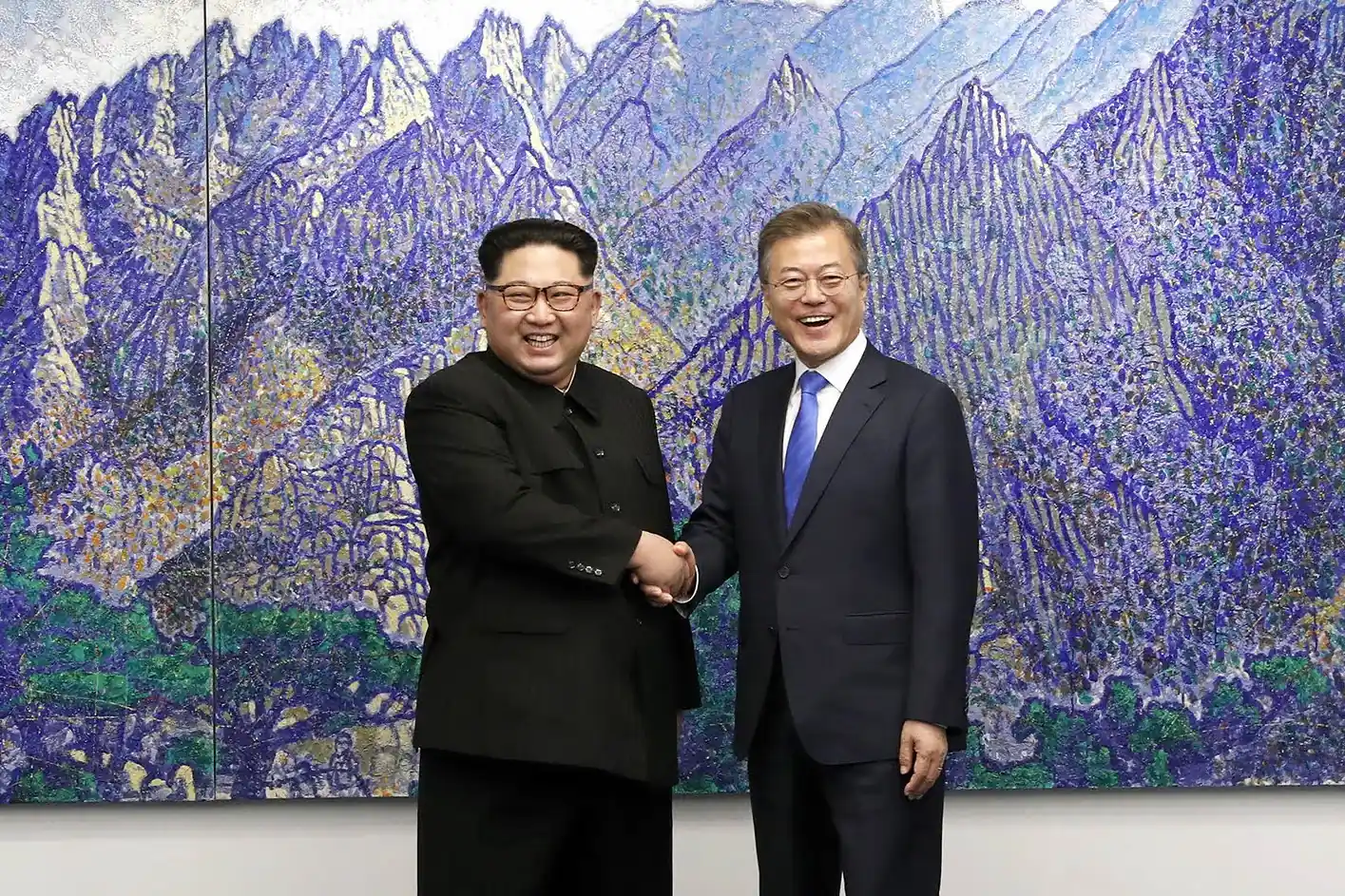 Moon Jae-in and Kim Jong-un shaking hands at the military demarcation line in Panmunjom, April 27, 2018