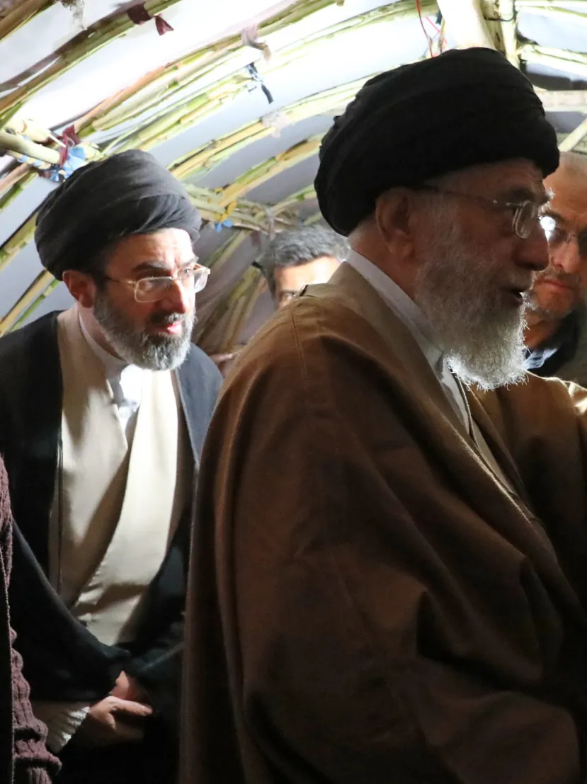 Ali Khamenei and his son Mojtaba, in clerical robes and black turbans