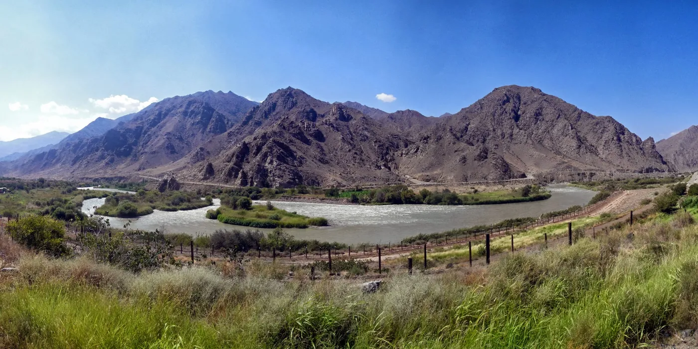 The Aras river winding through a dry mountain valley under a blue sky