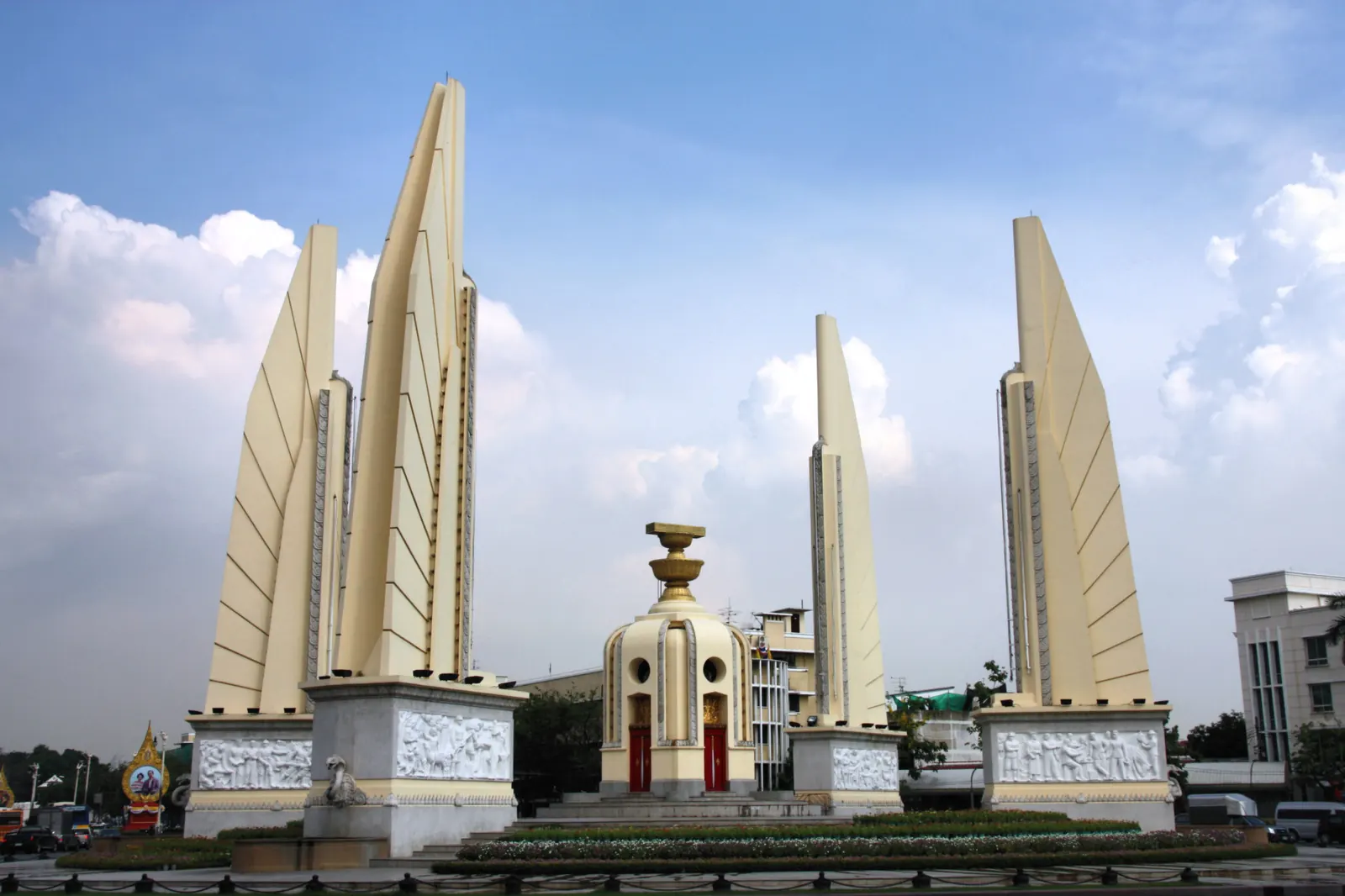 The Democracy Monument in Bangkok, a towering art deco structure surrounded by a traffic circle