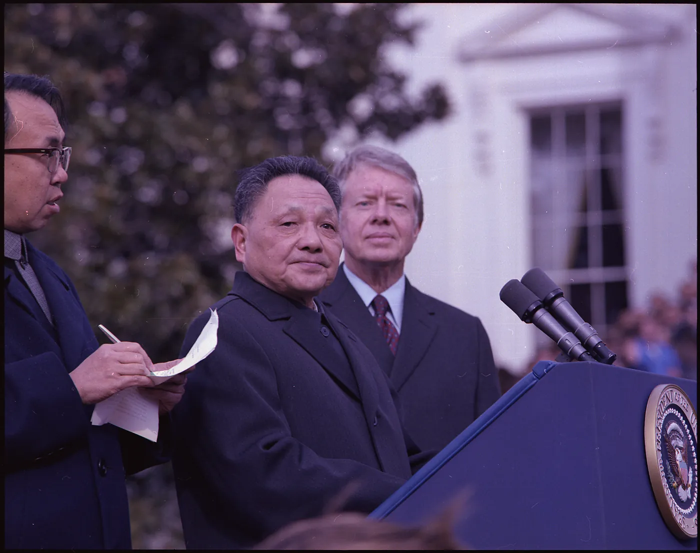 Deng Xiaoping at the presidential podium with Jimmy Carter behind him during the 1979 White House arrival ceremony