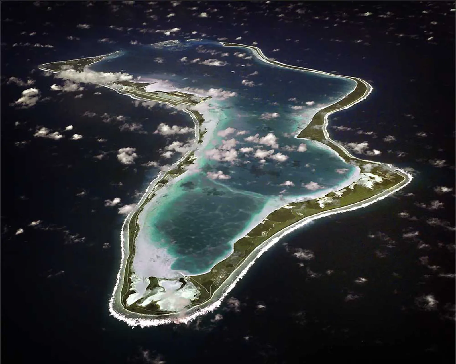 Aerial view of the US Navy facility on Diego Garcia, a coral atoll in the Indian Ocean, showing runways, hangars, and turquoise lagoon
