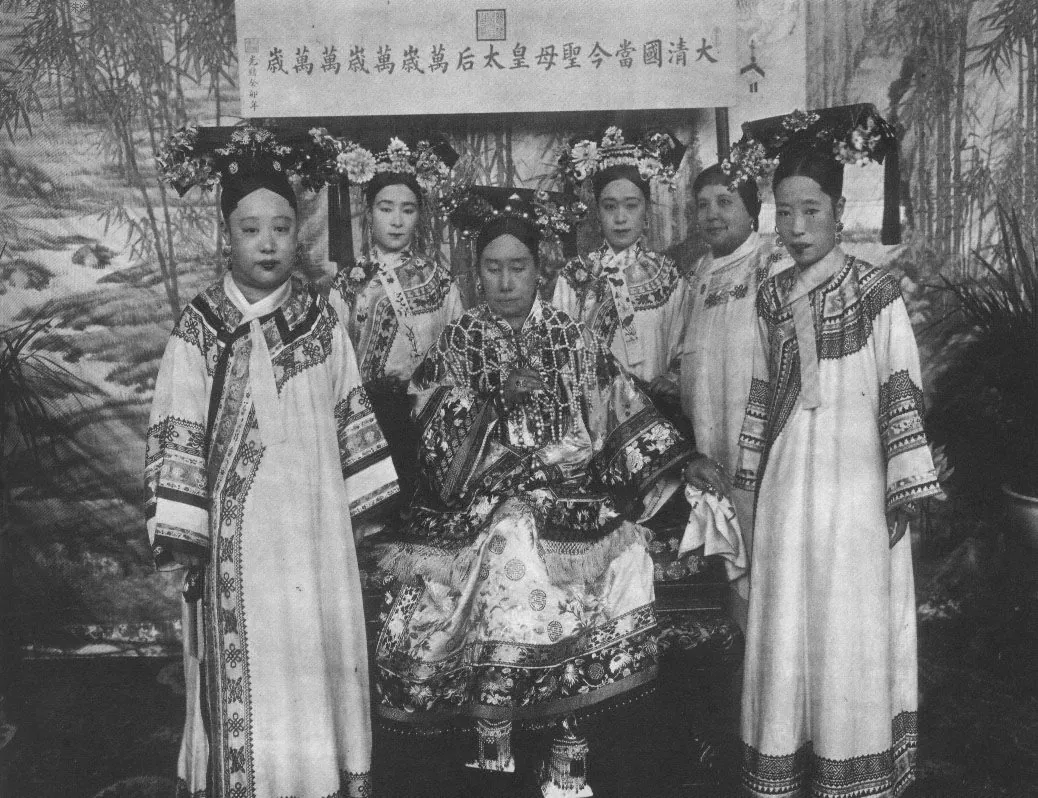Empress Dowager Cixi seated on an ornate throne in the Forbidden City, wearing elaborate court robes and a jeweled headdress, around 1903