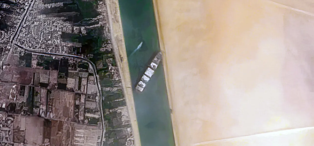 Satellite view of the Ever Given container ship wedged diagonally across the Suez Canal