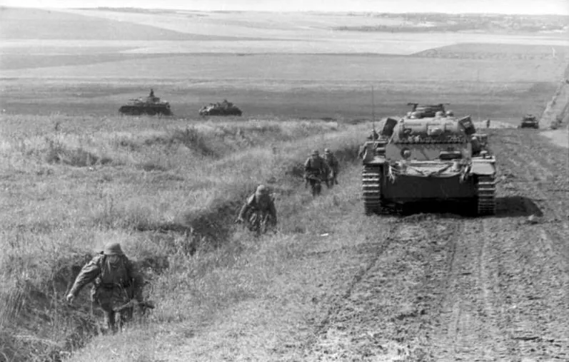 German tanks and soldiers advancing on a road in Russia during the opening phase of Operation Barbarossa