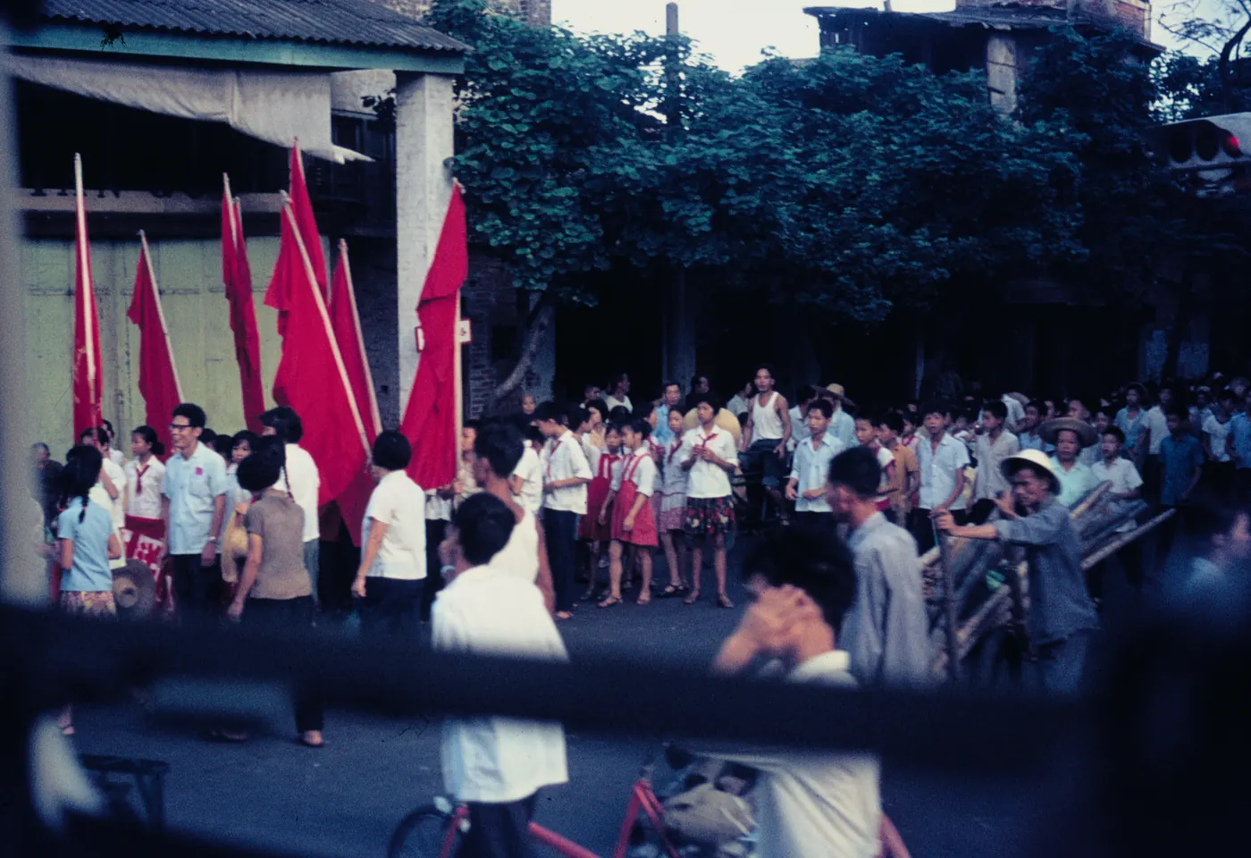 Young people carrying red flags gather in a Guangzhou street during the Cultural Revolution