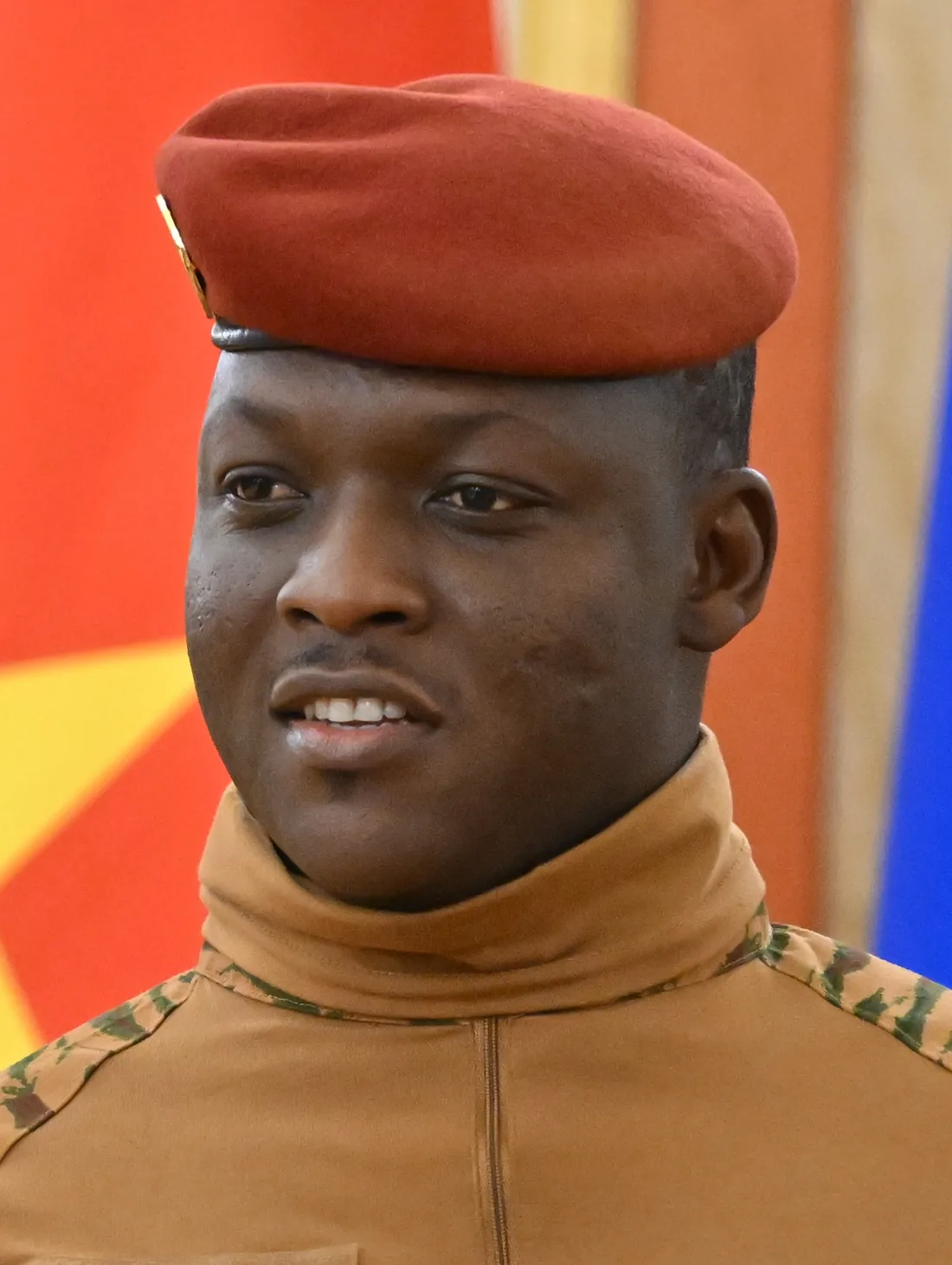 Portrait of Captain Ibrahim Traoré in a red beret and fatigues