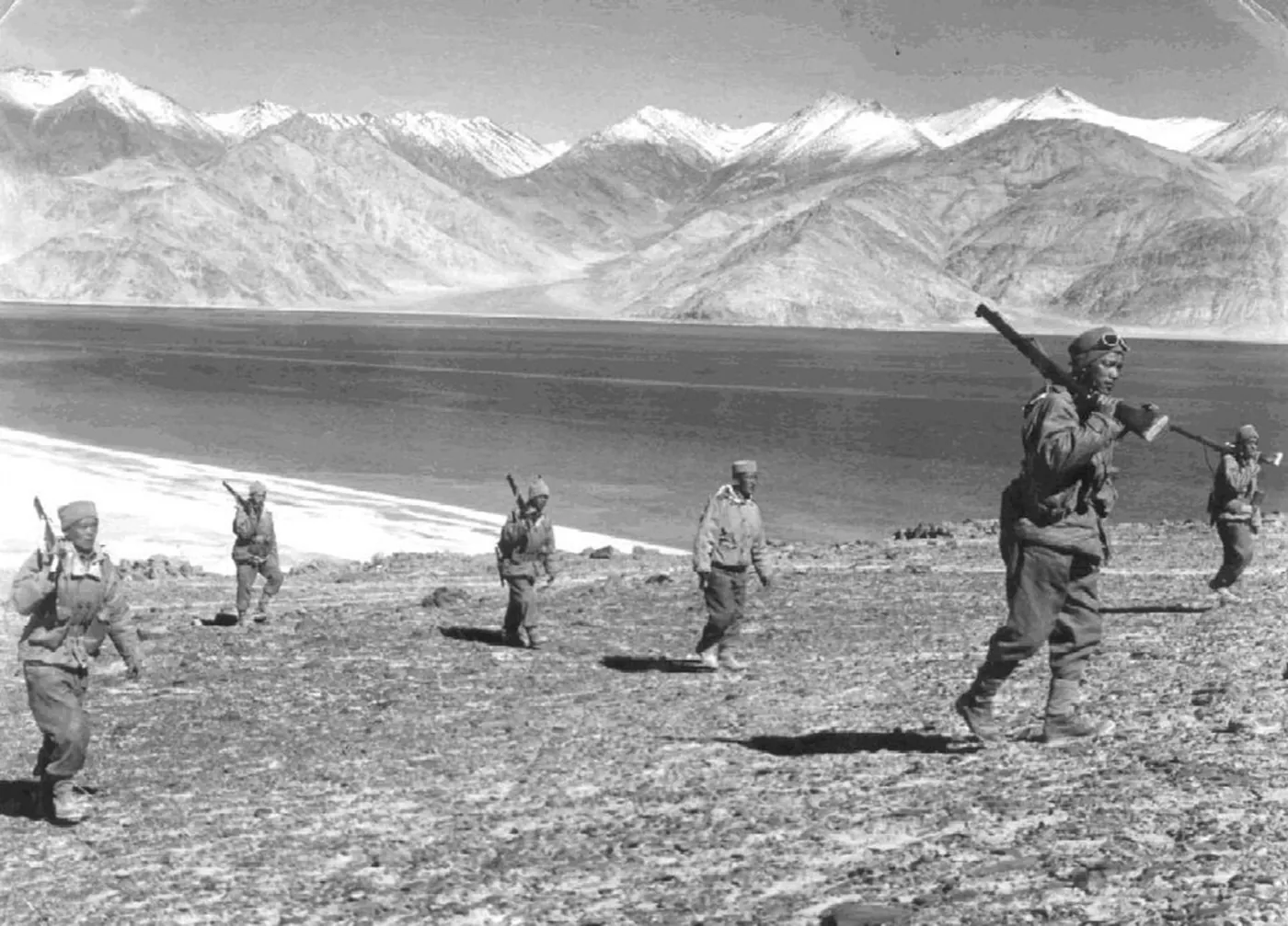 Indian soldiers carrying rifles on patrol in the Himalayan mountains during the 1962 Sino-Indian border war