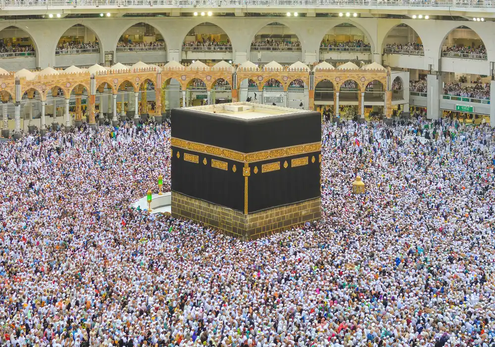 Aerial view of the Kaaba in Mecca surrounded by dense crowds of pilgrims