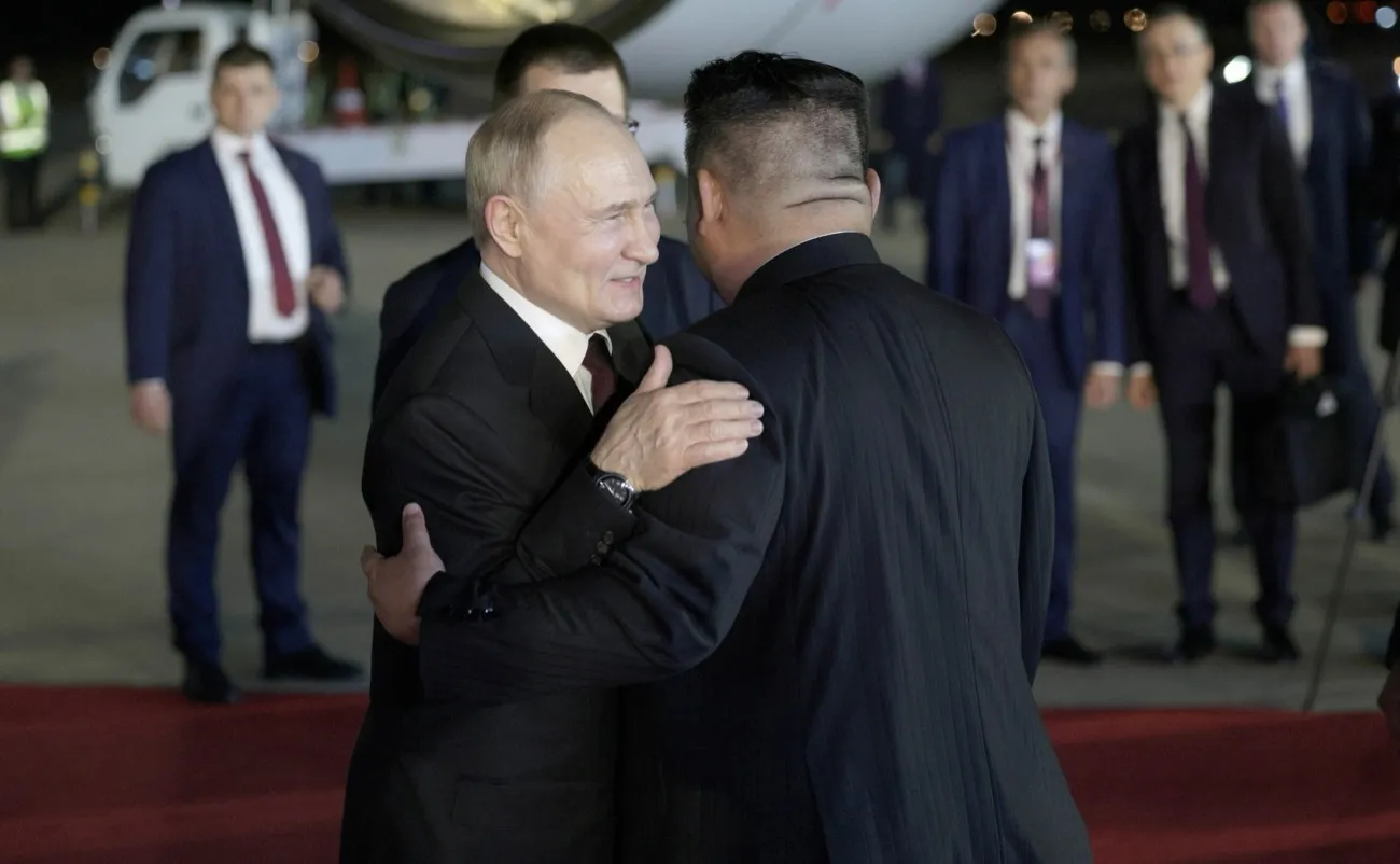 Kim Jong-un greeting Vladimir Putin on the tarmac at Sunan International Airport in Pyongyang, June 2024, with a red carpet and honor guard