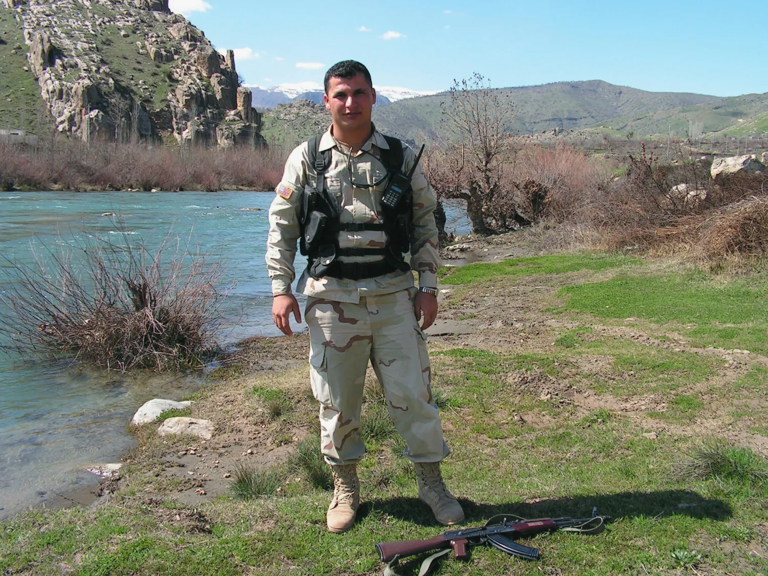 A Kurdish peshmerga soldier by a river in the mountains of Dohuk, northern Iraq