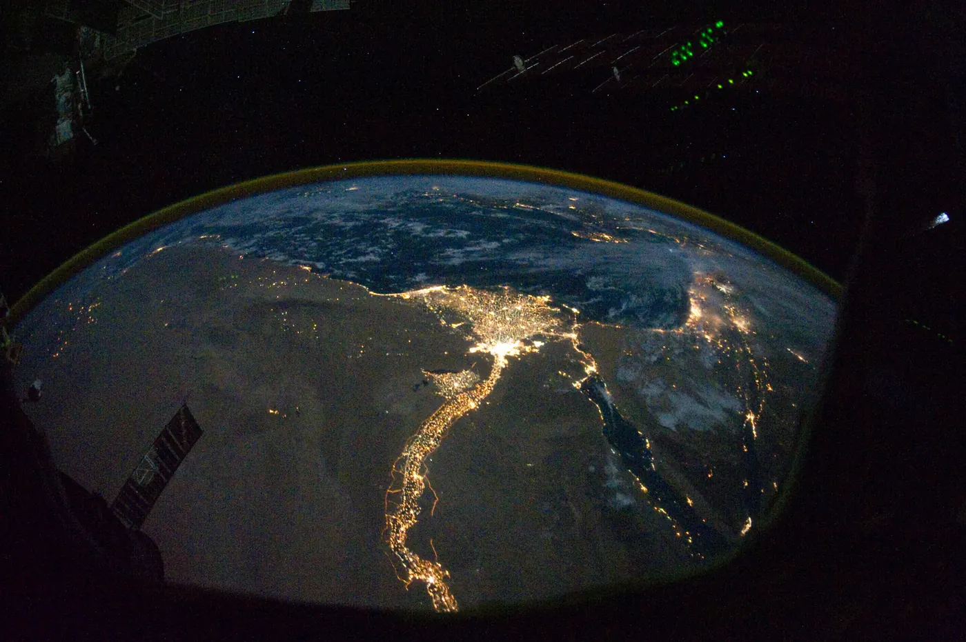 The Nile River and its delta at night as seen from the International Space Station, with city lights tracing the river through dark desert