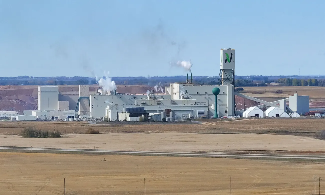 The Nutrien Cory potash mine near Saskatoon, Saskatchewan, with reddish tailings piles visible behind the processing facility