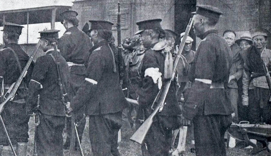 Revolutionary soldiers posing with rifles outside a building in Wuchang after the October 1911 uprising