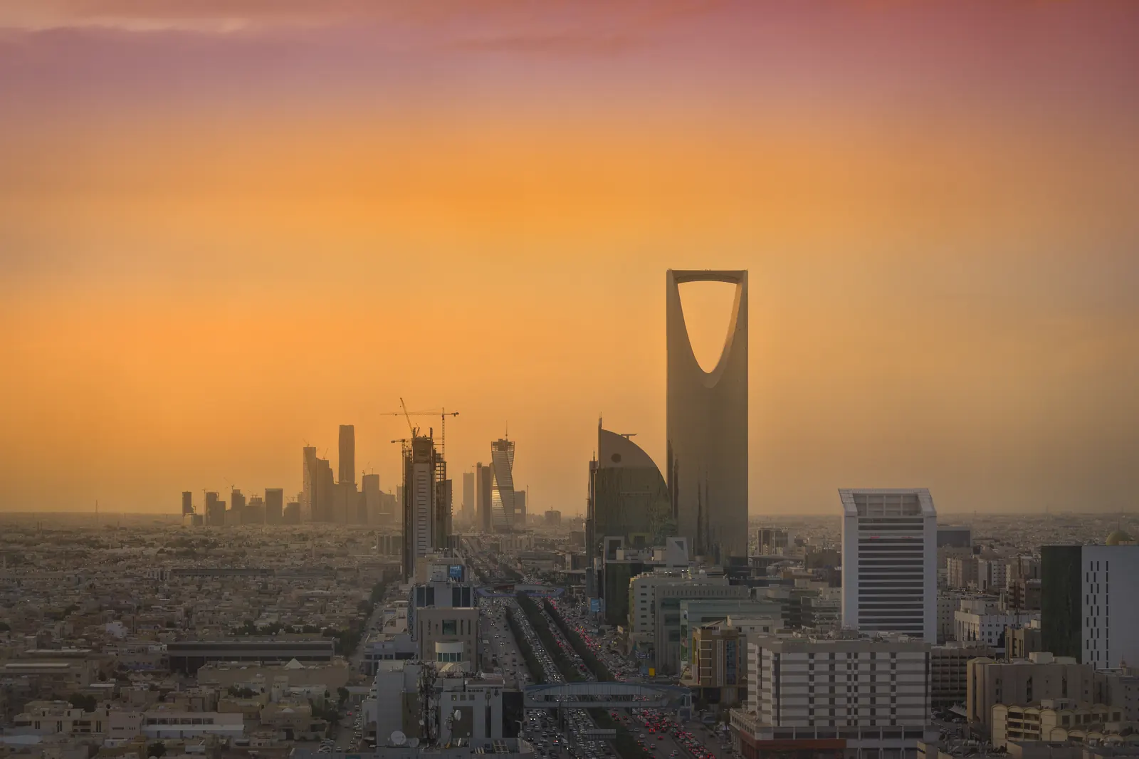 The Riyadh skyline at dusk, showing the King Abdullah Financial District towers and the Kingdom Tower