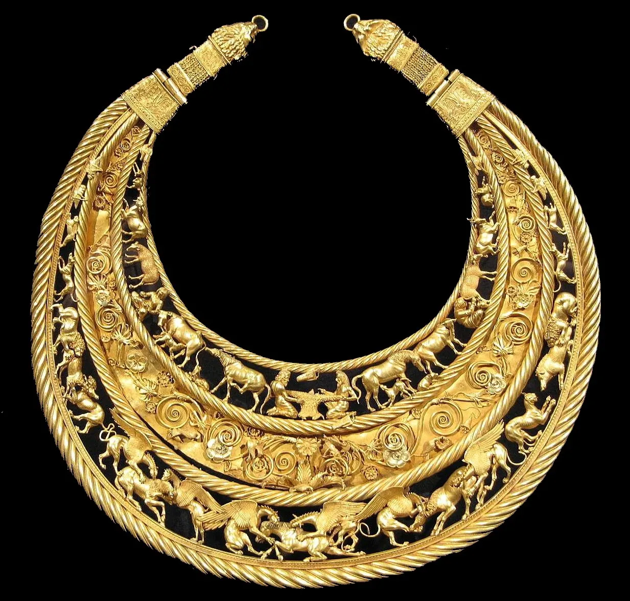 A crescent-shaped gold pectoral with three bands of intricate relief showing Scythian men, animals, and griffins