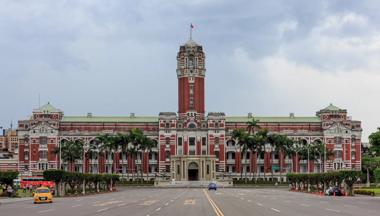 The Presidential Office Building in Taipei, a red-brick colonial building with a central tower, photographed from across Ketagalan Boulevard on a clear day