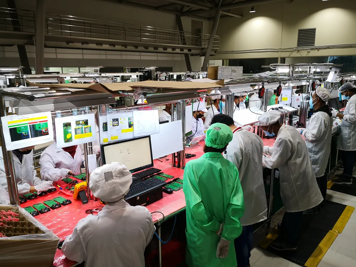 Workers on an iPhone assembly line at a Tata Electronics factory in India