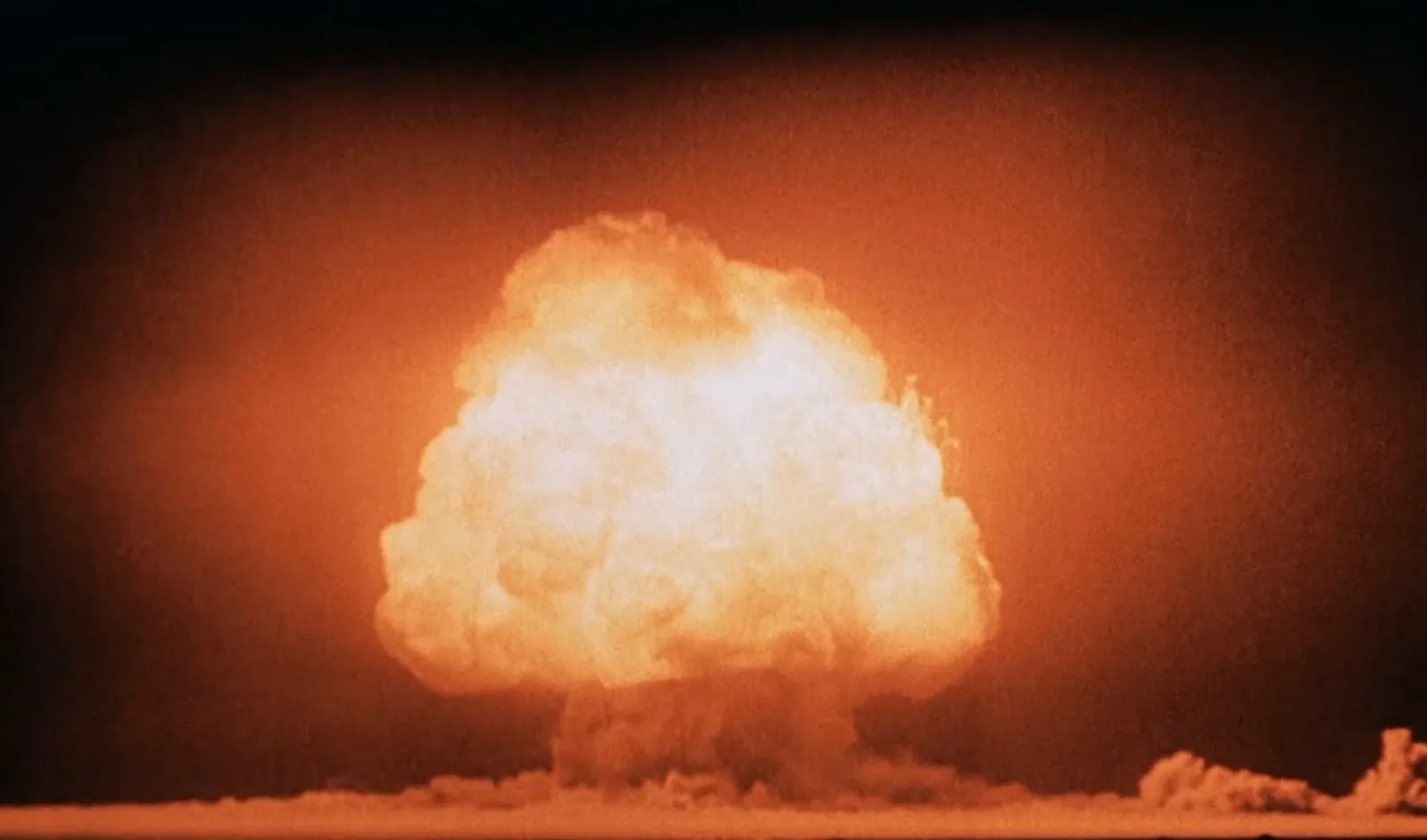 The mushroom cloud of the Trinity nuclear test rising over the New Mexico desert on July 16, 1945