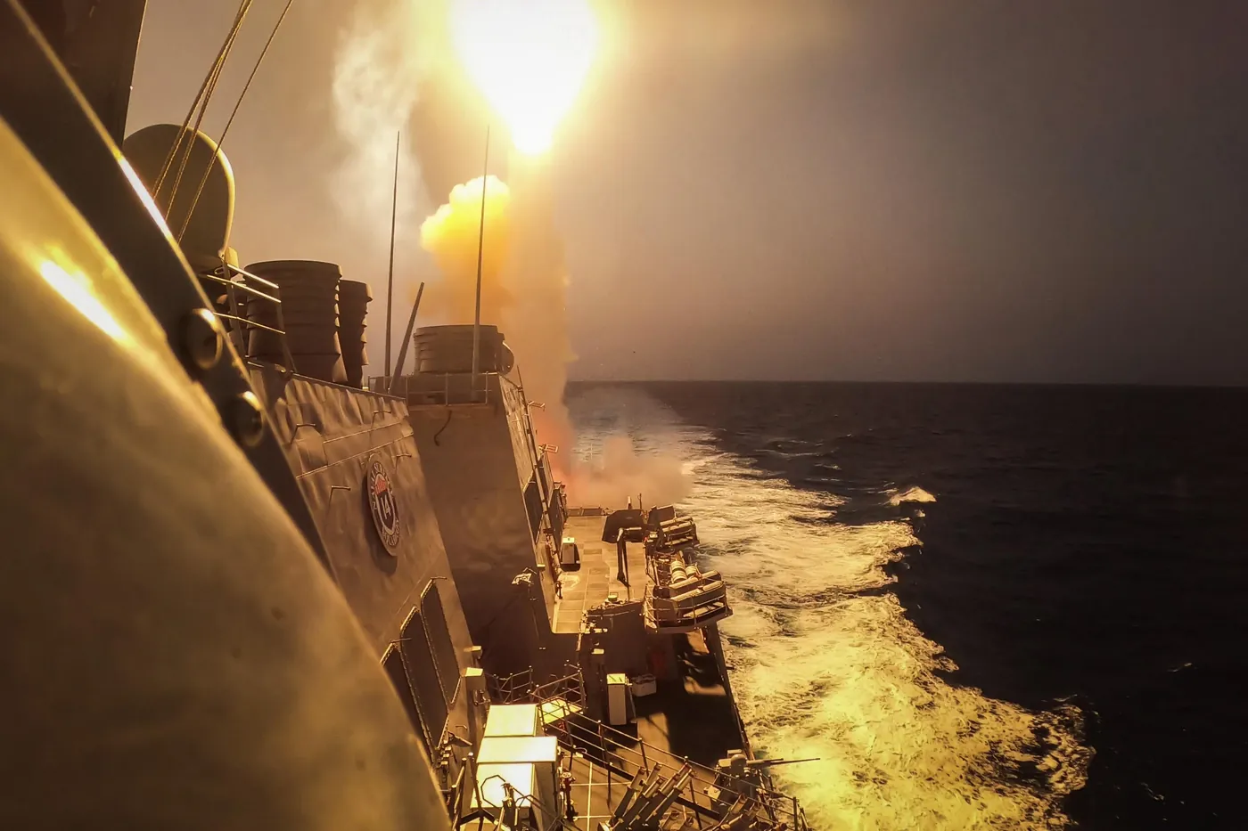 USS Carney firing an interceptor missile at night in the Red Sea