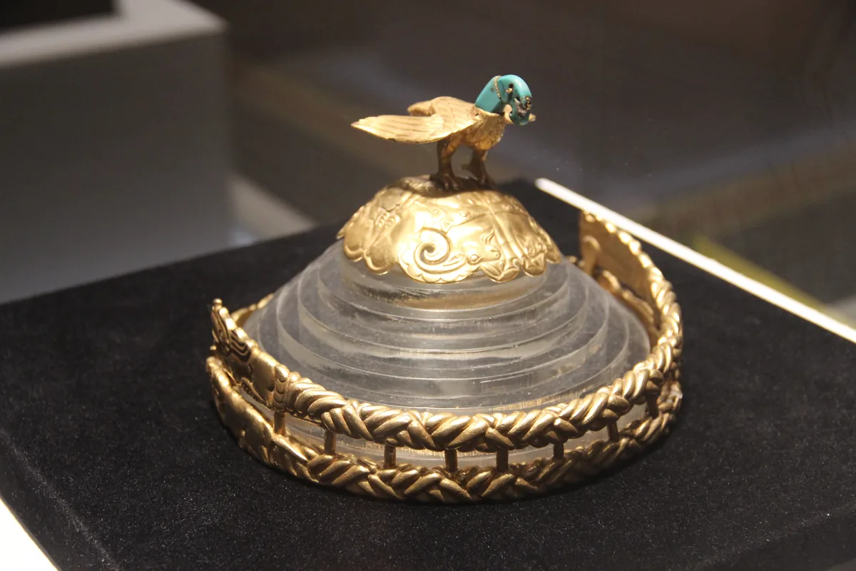 An elaborate gold crown topped with an eagle figure, from the Xiongnu nomadic culture