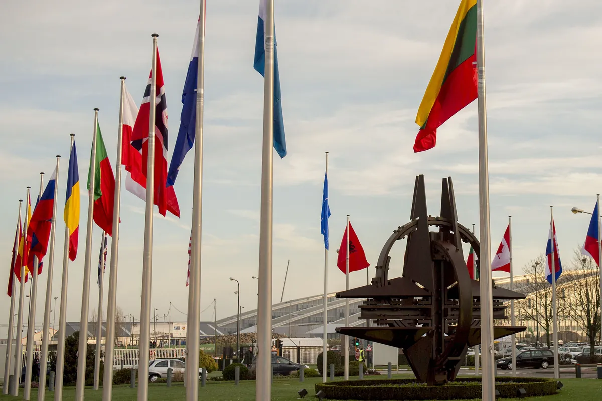 Member countries' flags surrounding the NATO star sculpture outside the alliance's headquarters