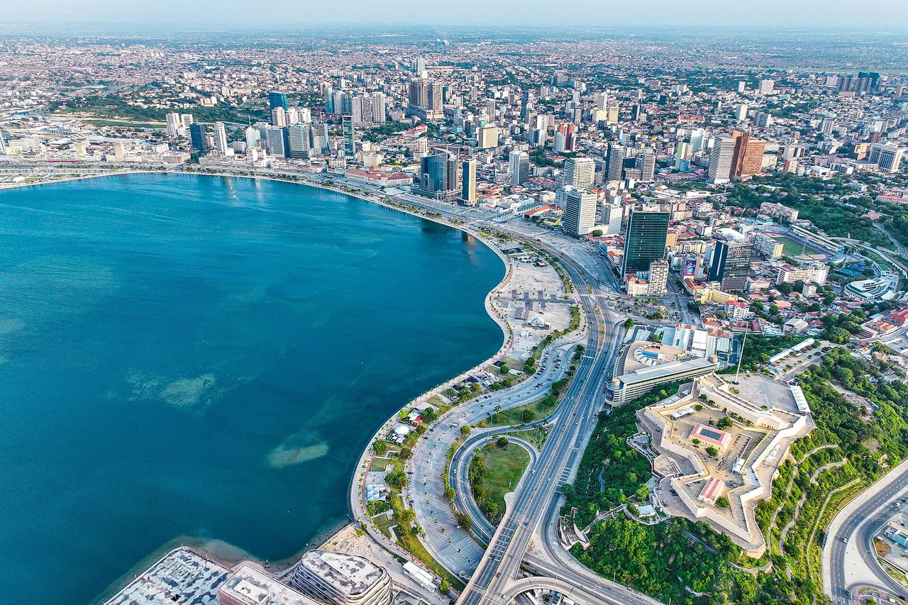 Aerial view of Luanda's curving bay, a seaside avenue and a star-shaped fortress in front of the city's towers