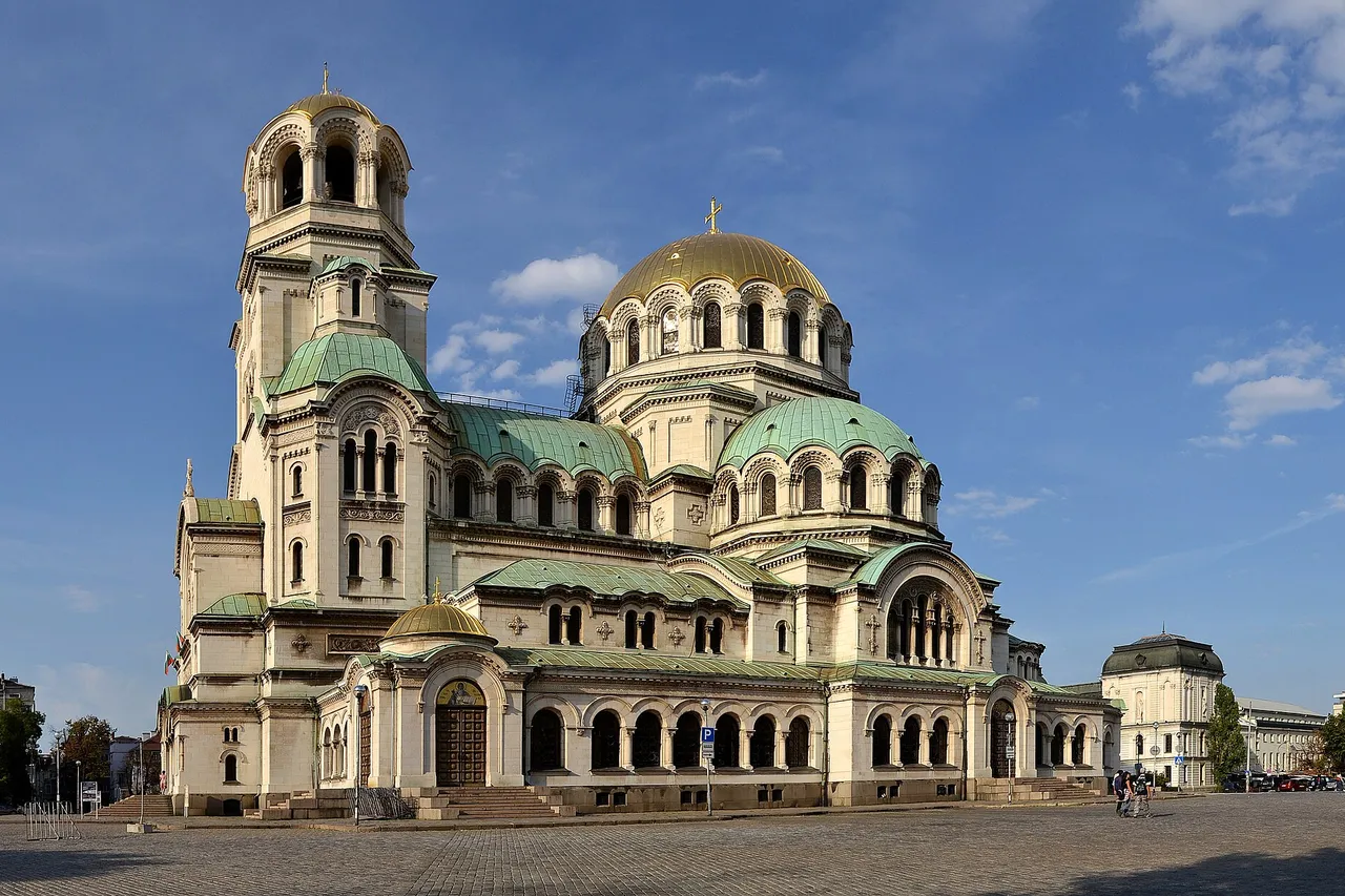 The Alexander Nevsky Cathedral in Sofia, with its gold and green domes and bell tower, under a blue sky