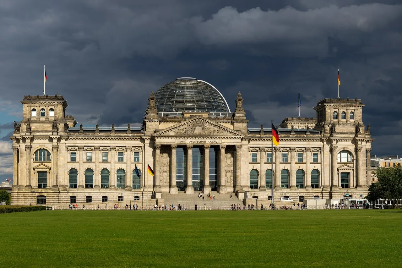 The Reichstag building in Berlin, seat of the Bundestag, under a dark sky