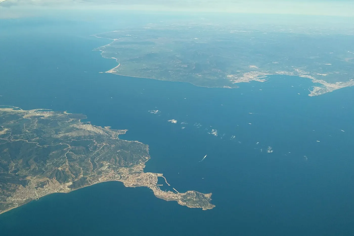 The Strait of Gibraltar seen from a plane, with Ceuta on a narrow peninsula of the African coast and the Spanish coast across the water
