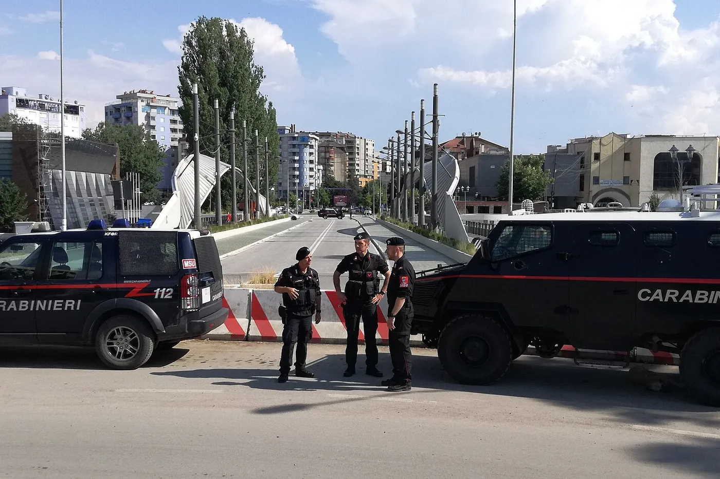Italian Carabinieri of the NATO peacekeeping force with two vehicles at the main bridge over the Ibar river in Mitrovica